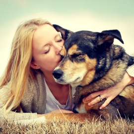 Woman Tenderly Hugging And Kissing Pet Dog